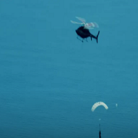 Helicopter catches falling rocket stage, but then drops it into the sea